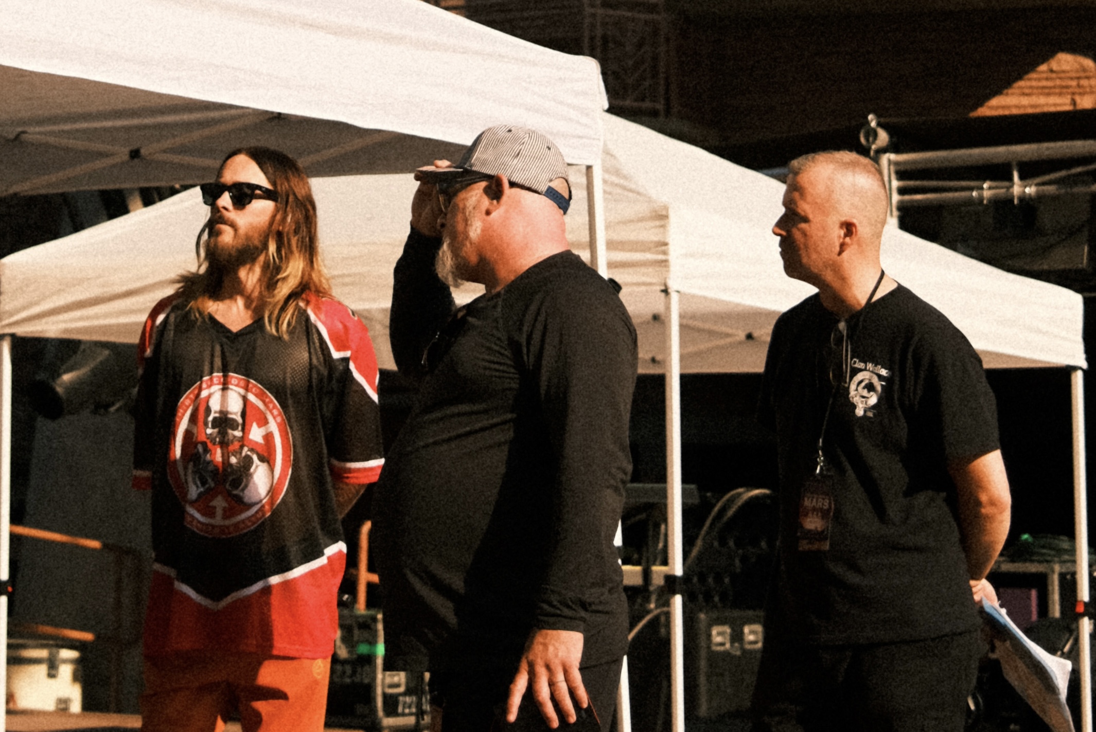 Crew members gathered outdoors at a live event